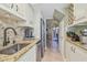 Updated kitchen with stainless steel appliances and granite countertops with adjoining dining and living rooms at 3632 Pine Cone Cir, Clearwater, FL 33760
