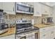 Modern kitchen with granite counters, stainless steel appliances, and a stylish tile backsplash at 3632 Pine Cone Cir, Clearwater, FL 33760