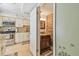 Bright, updated kitchen with a view to the half bathroom featuring shiplap walls at 3632 Pine Cone Cir, Clearwater, FL 33760