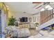 Comfortable living room with a TV, storage, accent chairs, and plenty of natural light at 3632 Pine Cone Cir, Clearwater, FL 33760