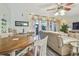 Cozy living room featuring a ceiling fan, comfortable seating, and sliding glass doors to the outside at 3632 Pine Cone Cir, Clearwater, FL 33760