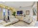 Living room with a TV, storage, and accent chairs near the entryway at 3632 Pine Cone Cir, Clearwater, FL 33760