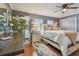 Comfortable bedroom with hardwood floors, neutral paint, ceiling fan, and ample natural light at 3632 Pine Cone Cir, Clearwater, FL 33760