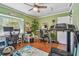 Well-lit home office space with dual workstations, ceiling fan, and a treadmill at 3632 Pine Cone Cir, Clearwater, FL 33760
