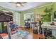 Home office with wood floors, a window view, and an organized desk space at 3632 Pine Cone Cir, Clearwater, FL 33760