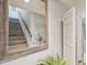 Stairway with wooden accents, a decorative mirror, and a plant on the landing at 3632 Pine Cone Cir, Clearwater, FL 33760