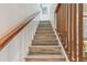 Stylish stairway with wooden railings, providing an elegant transition between floors at 3632 Pine Cone Cir, Clearwater, FL 33760