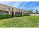 View of the backyard and screened-in porches with a manicured lawn at 4081 71St N Ter, Pinellas Park, FL 33781