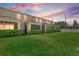 View of the backyard and screened-in porches with a manicured lawn at dusk at 4081 71St N Ter, Pinellas Park, FL 33781