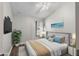 Relaxing bedroom features a tufted headboard, stylish decor, and ample natural light at 4081 71St N Ter, Pinellas Park, FL 33781