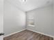 Empty bedroom boasts sleek wood floors, a bright window, and neutral paint at 4081 71St N Ter, Pinellas Park, FL 33781