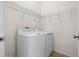 Convenient laundry room featuring a washer, dryer, and wire shelving at 4081 71St N Ter, Pinellas Park, FL 33781