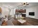Staged living room featuring hardwood floors open to a modern kitchen with an island and updated appliances at 4081 71St N Ter, Pinellas Park, FL 33781