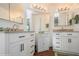 Well-lit bathroom featuring a double sink vanity with cabinets and granite countertops at 443 Tuna Ct, Oldsmar, FL 34677