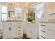 Bright bathroom featuring dual sinks, modern white cabinets and drawers, and ample lighting at 443 Tuna Ct, Oldsmar, FL 34677