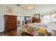 Comfortable bedroom featuring wood floors, a ceiling fan, and sliding mirror door closet at 443 Tuna Ct, Oldsmar, FL 34677