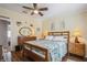 Cozy bedroom with wooden furniture, ceiling fan, hardwood floors and warm lighting at 443 Tuna Ct, Oldsmar, FL 34677