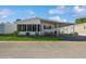 Charming home with a covered carport and an enclosed patio on a sunny day at 443 Tuna Ct, Oldsmar, FL 34677