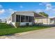 Charming home with a covered carport and an enclosed patio on a sunny day at 443 Tuna Ct, Oldsmar, FL 34677