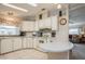 Bright kitchen featuring a breakfast bar, white cabinets, and modern appliances for convenient meal preparation at 443 Tuna Ct, Oldsmar, FL 34677