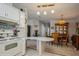Bright kitchen with white appliances and cabinets open to the dining area, perfect for easy entertaining at 443 Tuna Ct, Oldsmar, FL 34677