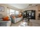Warm living room featuring a entertainment center, comfortable seating, and soft natural light at 443 Tuna Ct, Oldsmar, FL 34677