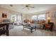 Inviting living room featuring neutral tones, comfortable seating, and natural light from sliding doors to an enclosed porch at 443 Tuna Ct, Oldsmar, FL 34677