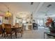 Open-concept living space with carpeted floors, seamlessly connecting the dining area, kitchen, and living room at 443 Tuna Ct, Oldsmar, FL 34677