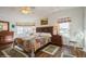 Inviting bedroom with hardwood floors, a large bed, and multiple windows offering plenty of natural light at 443 Tuna Ct, Oldsmar, FL 34677