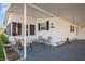 Cozy patio area with seating and a covered carport, ideal for outdoor enjoyment at 443 Tuna Ct, Oldsmar, FL 34677