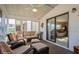 Relaxing sunroom with comfortable seating and an open view into the home's living space at 443 Tuna Ct, Oldsmar, FL 34677