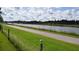 Scenic walking path along the canal with green grass and trees at 443 Tuna Ct, Oldsmar, FL 34677