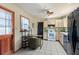 Charming kitchen features white appliances, island counter, and stylish tropical wallpaper at 4621 4Th N Ave, St Petersburg, FL 33713