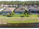 Backyard view featuring a screened-in pool and lush green lawn in a beautiful neighborhood at 4681 Night Star Trl, Odessa, FL 33556