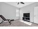 Neutral bedroom with a ceiling fan, a window, carpeted floor, and a TV on top of a dark stand at 4681 Night Star Trl, Odessa, FL 33556