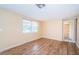 Cozy bedroom featuring laminate floors, a double window, and neutral paint at 4811 Daphne St, New Port Richey, FL 34652