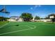 Outdoor basketball court with green surface and clear markings, ideal for sports and recreation at 527 Scotland St, Dunedin, FL 34698