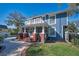 Back exterior of home with porch and balcony features a well-manicured lawn at 527 Scotland St, Dunedin, FL 34698