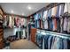 Well-organized walk-in closet featuring built-in shelving, drawers, hanging rods, and a carpeted floor at 527 Scotland St, Dunedin, FL 34698