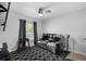 Living room featuring a reclining love seat, ceiling fan, and graphic rug at 5383 Black Pine Dr, Tampa, FL 33624