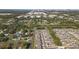 Panoramic aerial view of a residential area near an industrial area and a body of water, filled with greenery and modern homes at 7229 Spring Snowflake Ave, Tampa, FL 33619