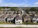 Expansive aerial view of a residential community featuring modern homes and well-maintained streets on a sunny day at 7229 Spring Snowflake Ave, Tampa, FL 33619