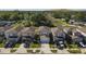 Aerial view of a neighborhood with well-maintained homes, green lawns, and paved driveways at 7229 Spring Snowflake Ave, Tampa, FL 33619