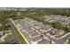 Scenic aerial shot of a community with a pond, surrounded by lush greenery and neatly arranged modern homes at 7229 Spring Snowflake Ave, Tampa, FL 33619