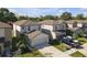 Aerial view showcases modern two-story homes, lawns, and driveways in a residential neighborhood at 7229 Spring Snowflake Ave, Tampa, FL 33619