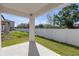 Covered patio with view of backyard and white fence at 7229 Spring Snowflake Ave, Tampa, FL 33619