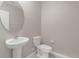 Bathroom with a pedestal sink, a toilet and neutral paint at 7229 Spring Snowflake Ave, Tampa, FL 33619