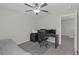 Neutral bedroom with ceiling fan, carpet, and adjacent office space at 7229 Spring Snowflake Ave, Tampa, FL 33619