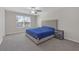 Bedroom with a light grey padded headboard, neutral walls and plush carpeting at 7229 Spring Snowflake Ave, Tampa, FL 33619