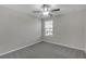 Unfurnished bedroom with neutral walls, carpet, ceiling fan, and window at 7229 Spring Snowflake Ave, Tampa, FL 33619